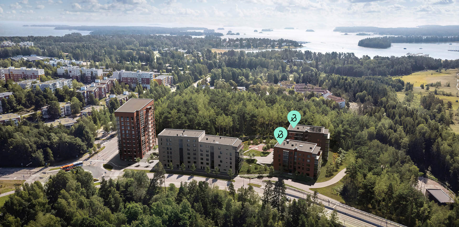 Visualisointi - Ilmakuva asuinalueesta, jossa näkyy kolme kerrostaloa metsän vieressä. Taustalla meri ja saaristo. Etualalla tie ja linja-auto.