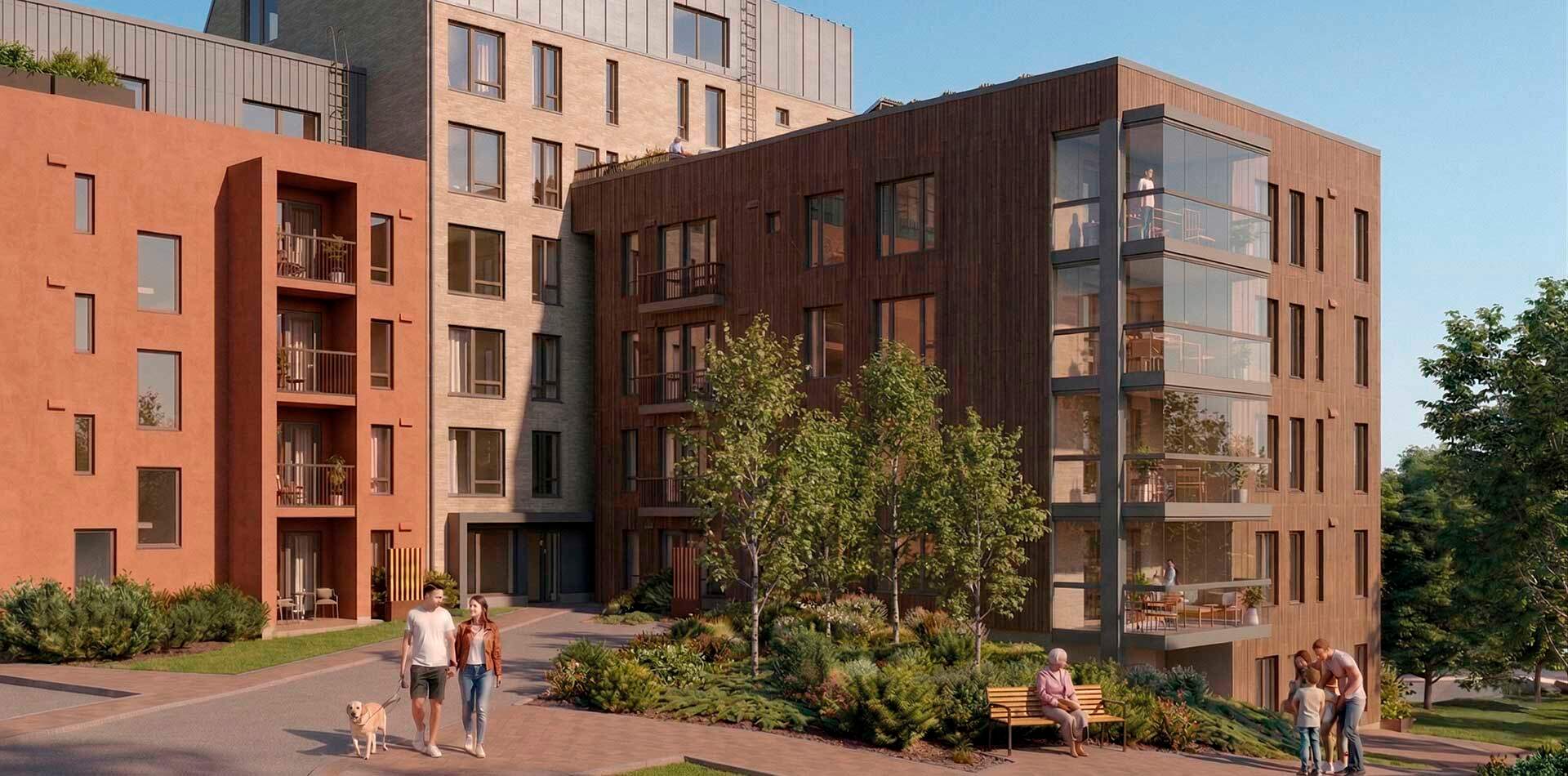 Valokuva - Ryhmä ihmisiä istuu ulkona pöydän ääressä. Pöydällä on kasveja, vesikannu, viinilaseja ja purkkeja. Yksi henkilö pitelee vauvaa sylissään.